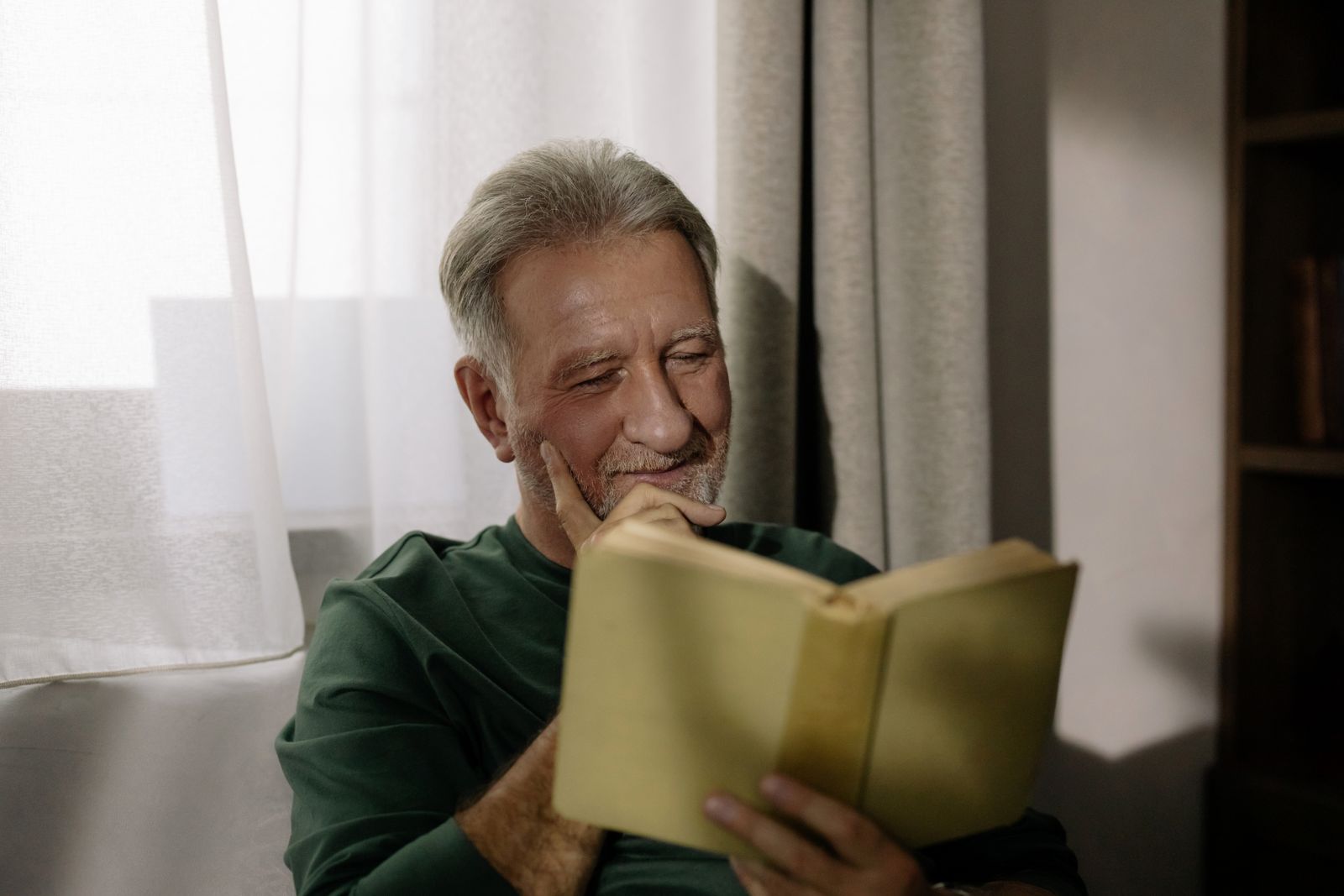 Man reading practical lifestyle information at home